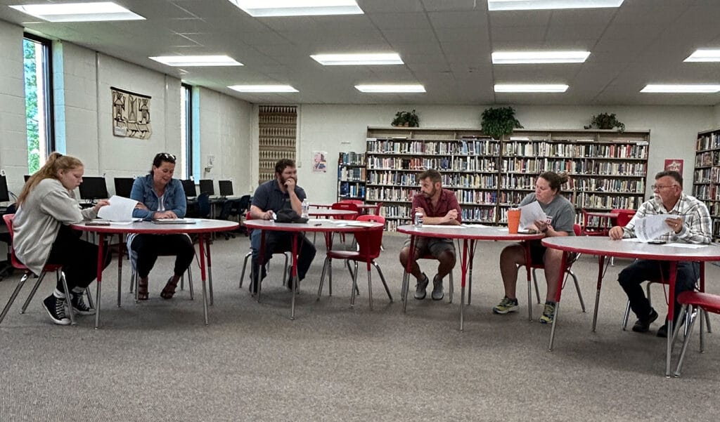 people talking in a school meeting