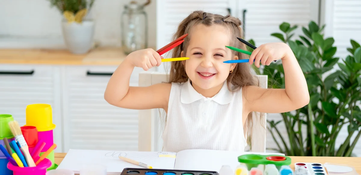 Kindergarten student drawing with color pencils