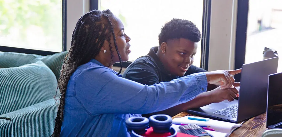 mom and son using the computer and smiling