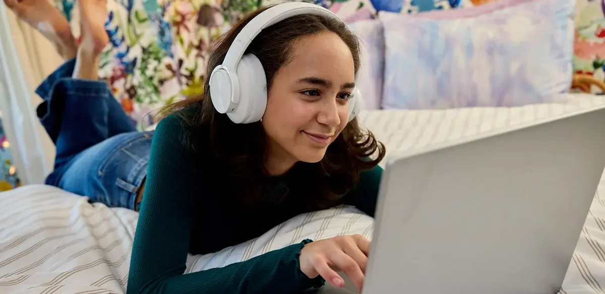 girl using her computer with big headphones