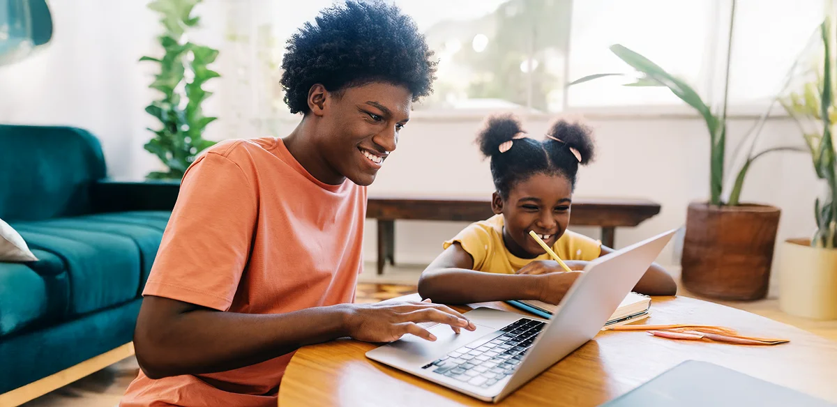 students smiling and using the computer